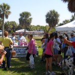 Lots of people lined up on the grass in the shade in T-shrts and shorts with their dogs and waited for the All Pet Care raffle