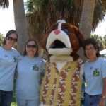 Emily, Lynda, Pam, and a gal in a big furry dog head pose for a photo at Mutt Strutt 2011